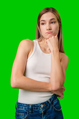 Wall Mural - Young Woman Thinking in a White Tank Top and Jeans Against a Green Screen