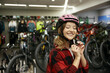 © Nomad_Soul - Portrait of happy smiling woman cyclist wearing safety helmet at sport shop