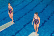 © Microgen - Female divers on the jumping board, showcasing their strength and agility. Precision and focus required for competitive diving