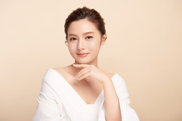 Wall Mural - Beautiful young asian woman with clean fresh skin on beige background, Face care, Facial treatment, Cosmetology, beauty and spa, Asian women portrait.