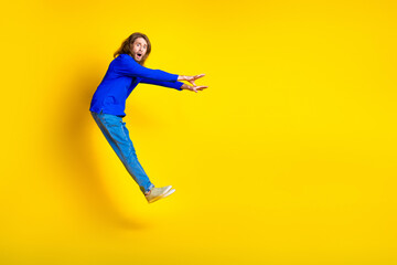 Canvas Print - Photo of worried nervous funny man wear trendy blue clothes fly empty space isolated on yellow color background