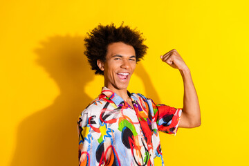 Sticker - Photo of nice young man raise fist wear shirt isolated on bright yellow color background