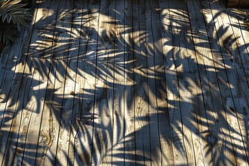 Wall Mural - Empty wooden table with shadow of tropical leaves on background with copy space