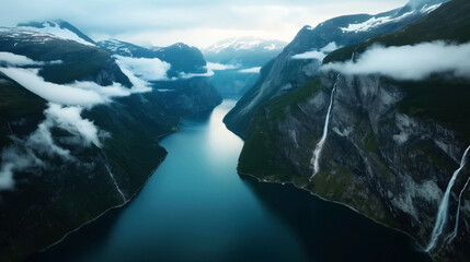 Sticker - A stunning panoramic view of a narrow fjord with steep cliffs, waterfalls, and low-hanging clouds under a cloudy sky.