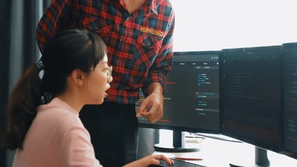 Slow motion back end or software developer manager supervising his team on new application program development on debugging and solving complex code algorithms on monitor. Burgeoning