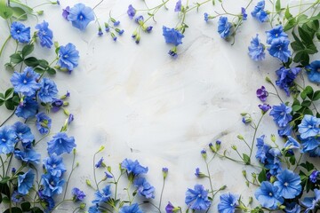 Wall Mural - Blue flowers are creating a frame on a white textured background with copy space in the center