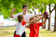 © famveldman - Family playing American football. Kids play rugby