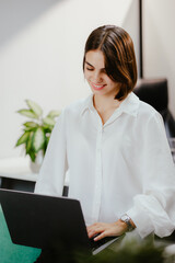 Wall Mural - Young Professional Woman Working on Laptop