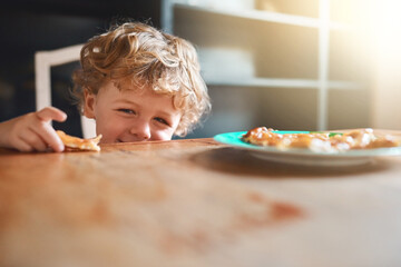 Wall Mural - Play, kid and boy eating food for healthy diet, nutrition or wellness in kitchen at home. Happy, hungry or child with lunch at table in plate for development, growth or meal for cute toddler in house