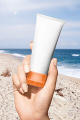 Sticker - Sunscreen tube png mockup at the beach for beauty brands