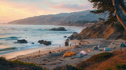 Poster - People camp on a sandy beach near the ocean at sunset. The sun is setting over the mountains in the distance.