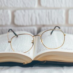 Aufkleber - An open book with eyeglasses laying on top, a white brick wall blurred in the background. Generative AI