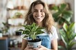 © Oleh - Happy young woman holding potted plant smiling at indoor garden center greenery store