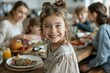 © Milos - A young girl with a joyous smile sits at a family dinner table, surrounded by loved ones, capturing a moment of happiness and familial love during a meal.