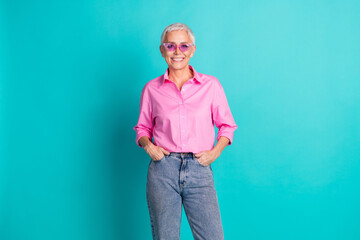 Poster - Photo of pretty aged woman posing wear pink shirt isolated on teal color background