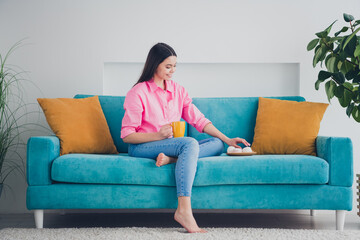 Wall Mural - Photo of shiny attractive girl dressed pink shirt drinking coffee eating snacks indoors house apartment room