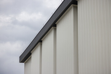 Sticker - A white building with a grey sky in the background