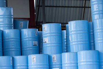 Wall Mural - A stack of blue barrels with stickers on them