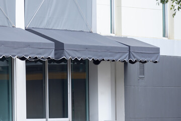 Poster - A large grey awning with a white trim