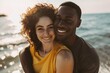 © CogniLens - Portrait of a content multiethnic couple in their 30s sharing a hug on the seashore