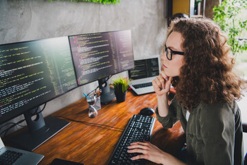 Photo of successful woman coder hacker web creator sitting armchair comfortable workspace workstation indoors