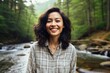 © Markus Schröder - Portrait of a smiling asian woman in her 20s wearing a comfy flannel shirt isolated in tranquil forest stream