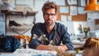 © imagemir - A man with glasses sits at a desk in a creative studio, looking directly at the camera