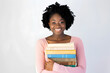 © RemsH - Portrait of happy young girl holding books over white background. Back to school