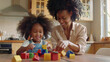 © VK Studio - A heartwarming scene of a mother and child enjoying playtime together, building structures with colorful toy blocks in a cozy kitchen.