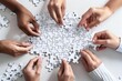 © Yuliia - Beautiful hands holding white jigsaw puzzles against a white background, working as a team to solve the pieces together.