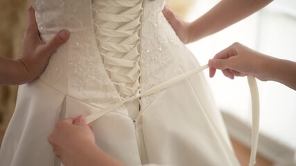 Poster - Close up of tying bow on elegant White bridal wedding dress