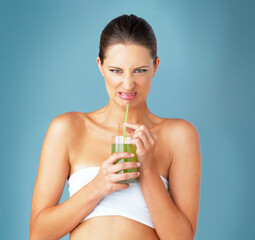 Sticker - Woman, portrait and disgust with green juice for diet in studio with organic detox, weight loss or wellness. Gut health, gross or upset person with vegetable smoothie for nutrition on blue background