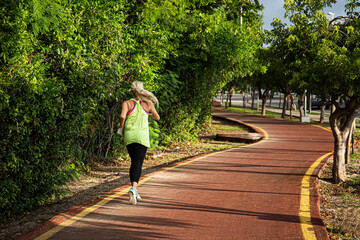 Wall Mural - fitness woman training and jogging in summer park. healthy and sport concept