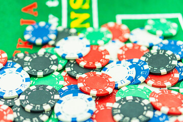 Poker Table With Poker Chips Turns In Casino. Many Poker Chips Spins on the Table in Darkness.