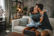 © Miljan Živković - Couple hug each other after online shopping on digital tablet