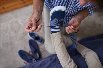 Wall Mural - Help, father and child tie shoes in bedroom for preparation, morning routine or getting ready on weekend. Top view, sneakers and man with kid for learning, growth development or support in home