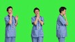 © DC Studio - Medical assistant feeling extremely sleepy against greenscreen backdrop, being overworked after the night shift. Woman nurse yawns and feels exhausted in studio, burnout and anxiety. Camera B.