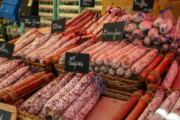 Wall Mural - Variety of homemade dried salami sausages in French butchery shop, Dordogne, France, meat food background close up