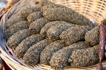 Variety of homemade dried salami sausages in French butchery shop, Dordogne, France, meat food background close up