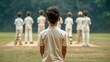 © lertsakwiman - A young boy observes his teammates preparing for a cricket match, showcasing teamwork and youth sports.