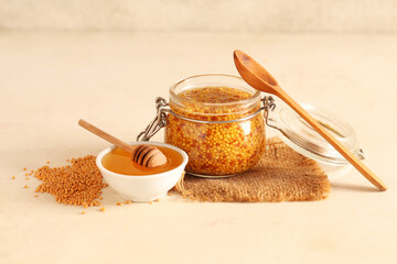 Wall Mural - Jar with Dijon mustard and bowl of honey on beige background