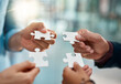 © Hira/peopleimages.com - Business people, puzzle and hands with teamwork, planning and cooperation for project, merger or support. Closeup, group or employees with creative solution, brainstorming or partnership with synergy
