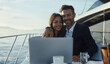 © Anna - A couple of businessmen are enjoying working on a luxury yacht with a laptop in their hands. For the promotion of luxury brands, corporate services, business content and luxury travel