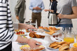 © New Africa - Coworkers having business lunch in restaurant, closeup