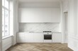© Chacmool - white modern kitchen in a house with marble walls