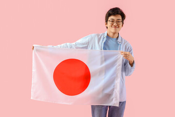 Sticker - Young Asian man with flag of Japan on pink background