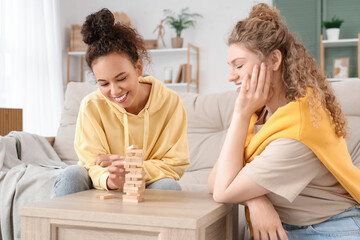 Sticker - Young women plying table game at home