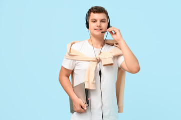 Poster - Teenage boy with tablet computer and headset working on blue background