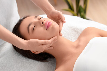 Wall Mural - Beautiful woman having facial massage in salon, closeup