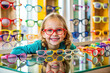 © Adisorn - A colorful array of glasses frames and mirrors fill a cheerful optician's table, awaiting a young girl's selection of her perfect new spectacles.